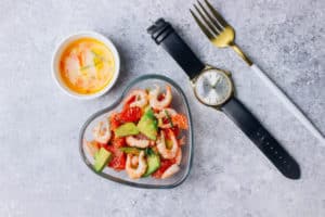 watch next to seafood and utensils