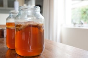 kombucha tea in glass jar with scoby